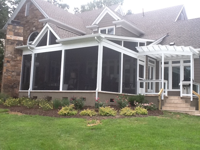 Screen Porch by Archadeck of Charlotte with outdoor fireplace and pergola