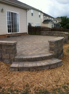 Archadeck of Charlotte designed and built this pave patio with paver steps and sitting walls